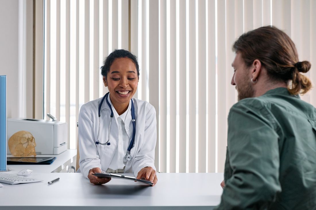 Doctor discussing the procedure with a patient in a bright clinic