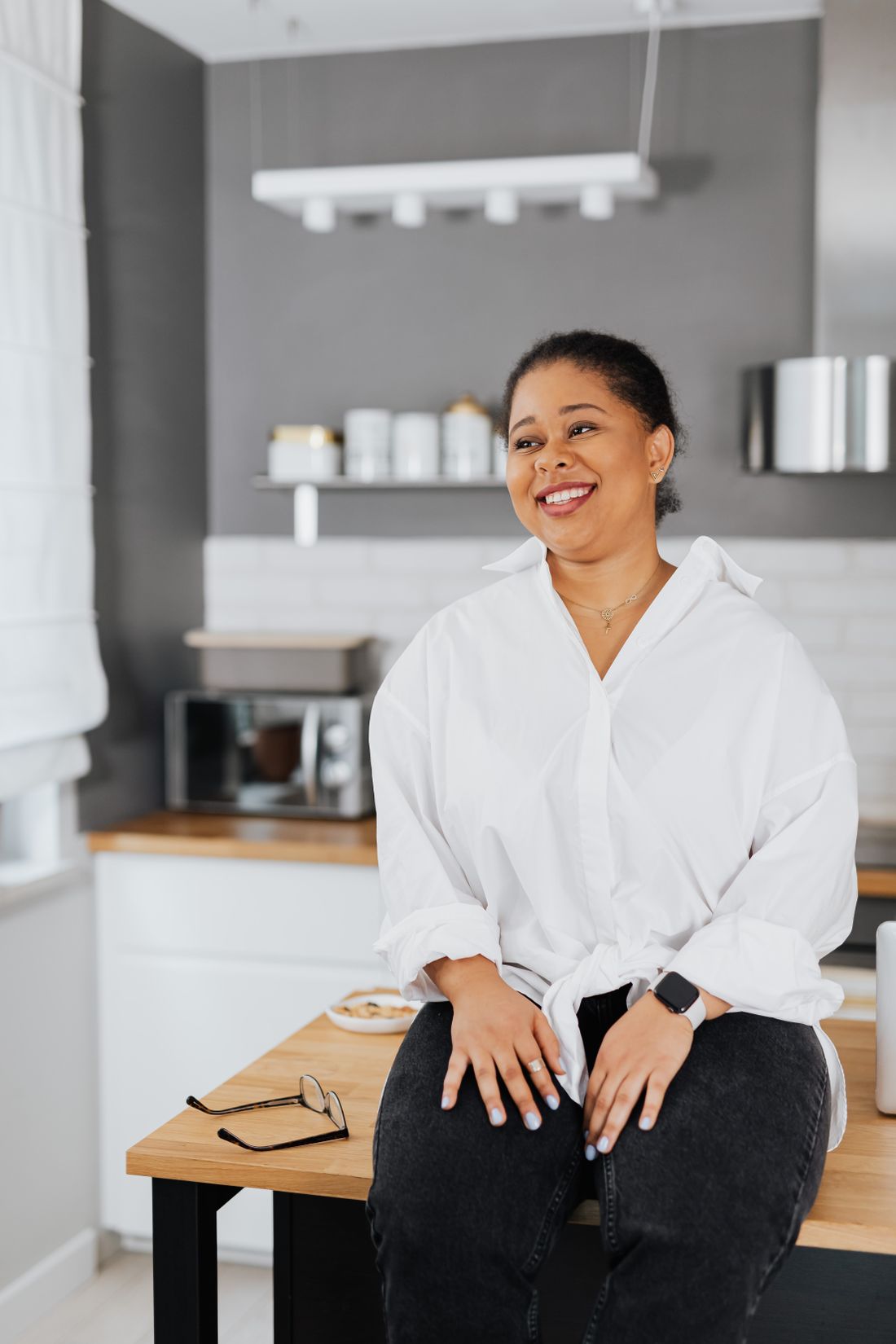 Happy, healthy woman in her thirties smiling at home
